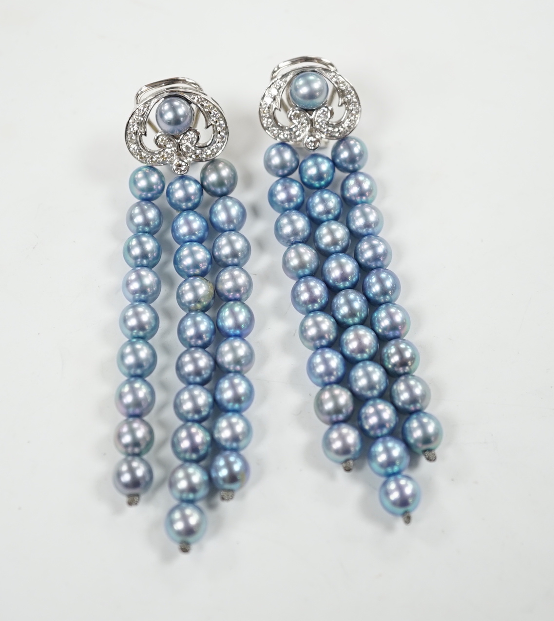 A modern pair of white metal, diamond chip cluster and bluey/grey three row cultured pearl tassel drop earrings, 89mm.